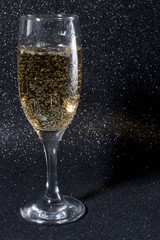 New year celebration in 2020. A glass of champagne on a black background.