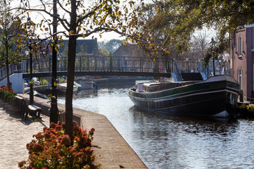 View on a historical  barge and footbridge in nostalgia Schipluiden