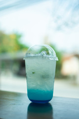 fresh ice drink on wooden table. soft focus.