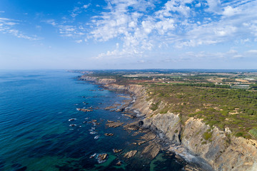 Fototapeta premium Aerial view of the coastline and cliffs near the Esteveira Beach in Aljezur, Algarve.