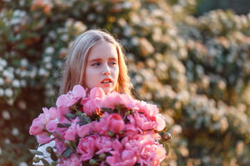 Fototapeta premium Very cute teenage girl with flowers in a red sundress posing