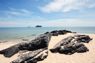 Beautiful seascape of the rocky beach and sea wave on seaside with blue sky at Samila beach in Thailand