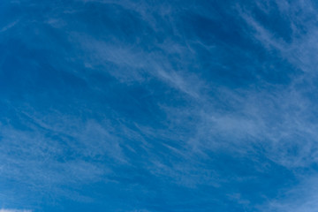 Wispy White Clouds High in a Blue Sky