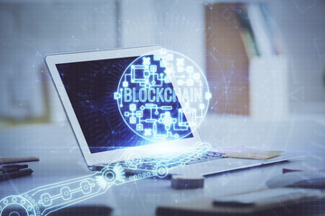 Multi exposure of blockchain theme hologram and table with computer background. Concept of bitcoin...