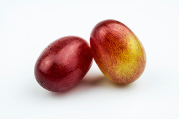 Two grapes of pink color isolated on a white background.