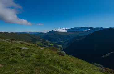 Fototapeta na wymiar Through the Vikafjell a pass road to Vik is located in the kommunes Hordaland and Sogne og Fjordane. Mountains with summer snow on background. July 2019