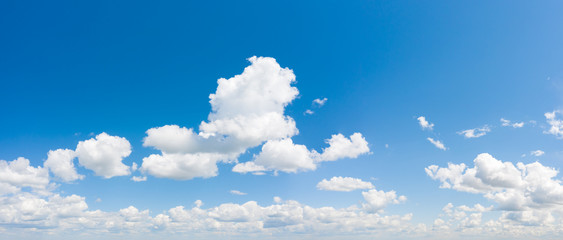 Panorama of blue sky with white cumulus clouds. Natural background