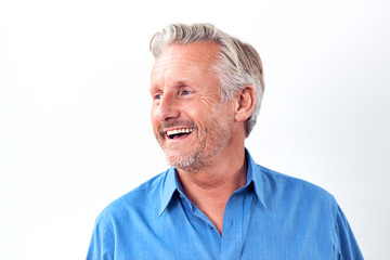 Studio Shot Of Mature Man Against White Background Laughing At Camera