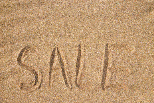 The inscription sale on the sand