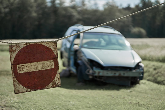 Old Car On The Road And Stop Sign