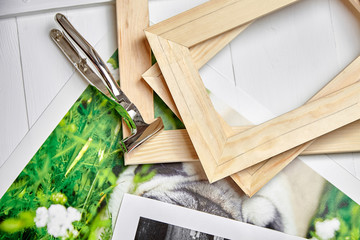 Canvas pliers and photography canvas prints. Tool for wrapping, colorful photos, pile of wooden stretcher bars, top view