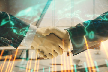 Multi exposure of financial chart and map on office background with two businessmen handshake....