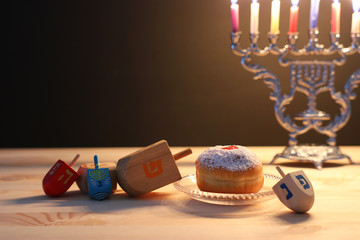 religion image of jewish holiday Hanukkah background with menorah (traditional candelabra), spinning top and doughnut