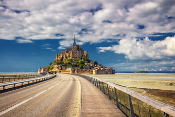 Beautiful panoramic view of famous Le Mont Saint-Michel tidal island with blue sky. Normandy,...
