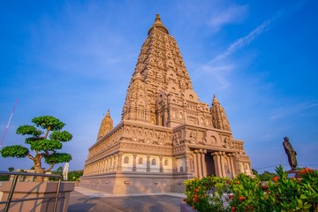 Fototapeta premium Mahabodhi Temple or Bodh Gaya Pagoda at Wat-Panyanantaram sunrise and beautiful sky, Wat Panyanantaram is famous pagoda and popular for traveler near bangkok at Pathum Thani, Thailand