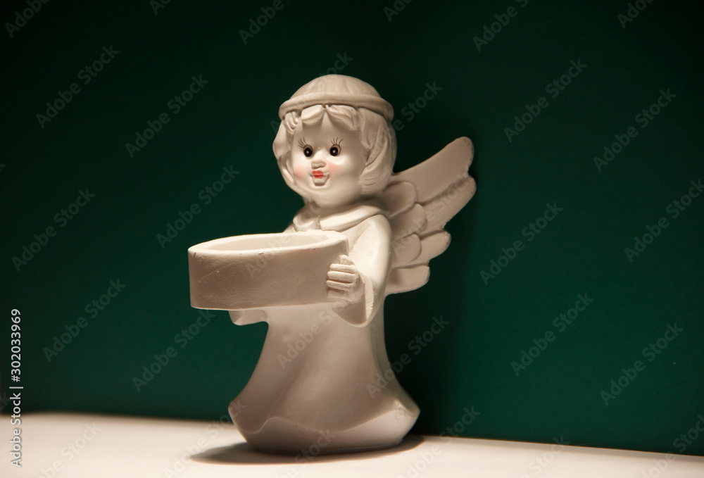 Wall mural Little angel with wings on green background