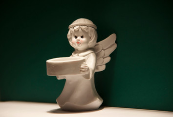Little angel with wings on green background