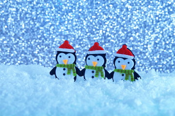 Merry Christmas and happy New Year greeting card with copy-space. penguins standing in winter Christmas landscape. Winter background