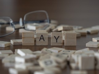 The concept of ay represented by wooden letter tiles