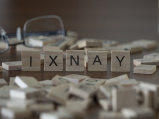 The concept of ixnay represented by wooden letter tiles
