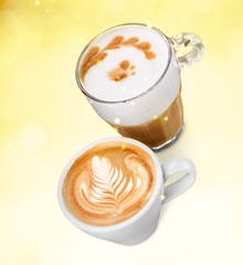 Two cups of coffee with cream on a yellow background