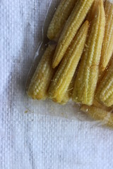 Close up of baby corns in a transparent plastic packet