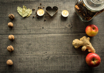 Collage frame with christmas baking / cooking ingrediens. Wooden background and christmas decorations related to cooking. Free copy space for text