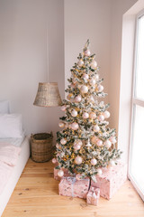 Christmas bedroom interior with Christmas tree and lights.