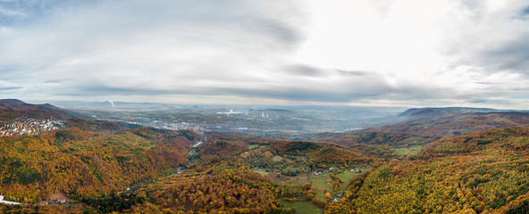 Autumn colorfull forest aerial panorama with factory