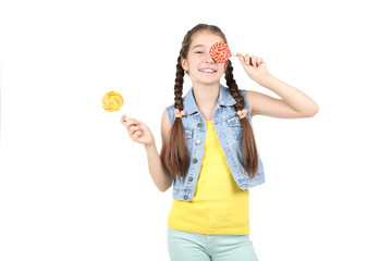 Beautiful young girl with sweet lollipops on white background