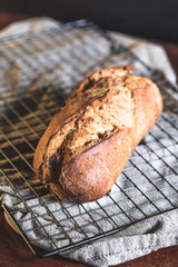 wholemeal bread on a grill with a grey towel