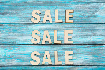 Word Sale by wooden letters on blue table