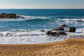 Beautiful beach in Porto, Portugal. Beautiful Atlantic ocean sparkling in the sun. Porto, Portugal.