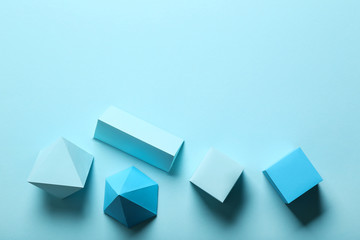 Paper geometric figures on blue background