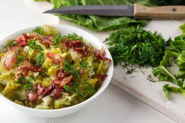 Stewed young cabbage with dill and grilled bacon.