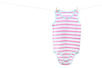 Baby clothes hanging on white background