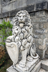 Lion statue on the slope. Old sculpture.