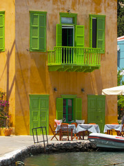 Fototapeta na wymiar colorful houses AT Mediterranean Coast in Greece