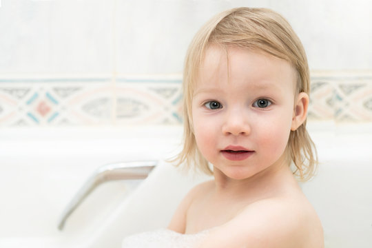 little girl bathes in a bubble bath. children love to swim