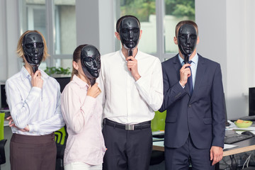 Faceless, nameless group office employees - concept. Men and women hide their faces with a black mask.