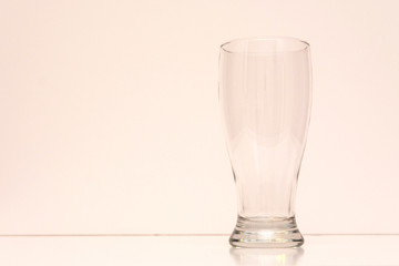 Empty transparent glass for beer on a light background