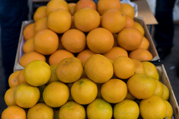 Tangerines on counter for sale.