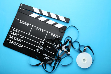 Clapper board with tape on blue background