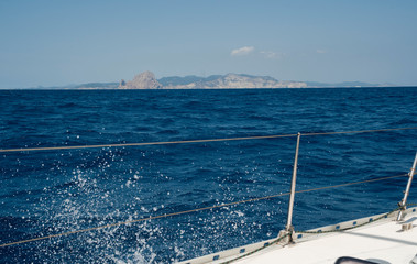 Fototapeta na wymiar port of sailboat with open Genoa the city of Ibiza in the background
