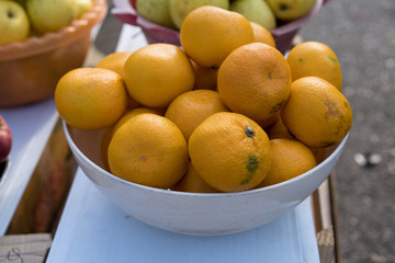 Tangerines on counter for sale.