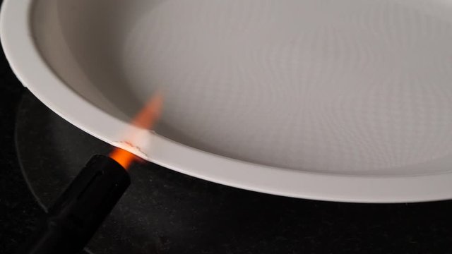 Torchis melting part of a plastic plate. Go green concept. Protect environment. 