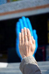 The Middle Way sculpture. Nikolaev, Ukraine, September 2019: Art object in the form of a huge blue hand - symbol meaning friendship and communication. The author is Romanian sculptor Bogdan Rake.