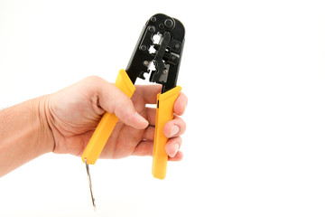 Crimper on a white background with copy space. hand holds tool for crimping twisted pair on white...