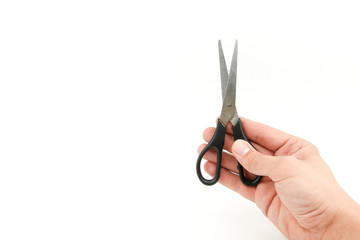 man's hand is holding a scissors on a white background with copy space.