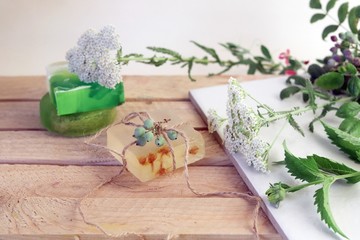 Natural soap, plants and berries on a wooden table, spa procedures, body care, healthy lifestyle